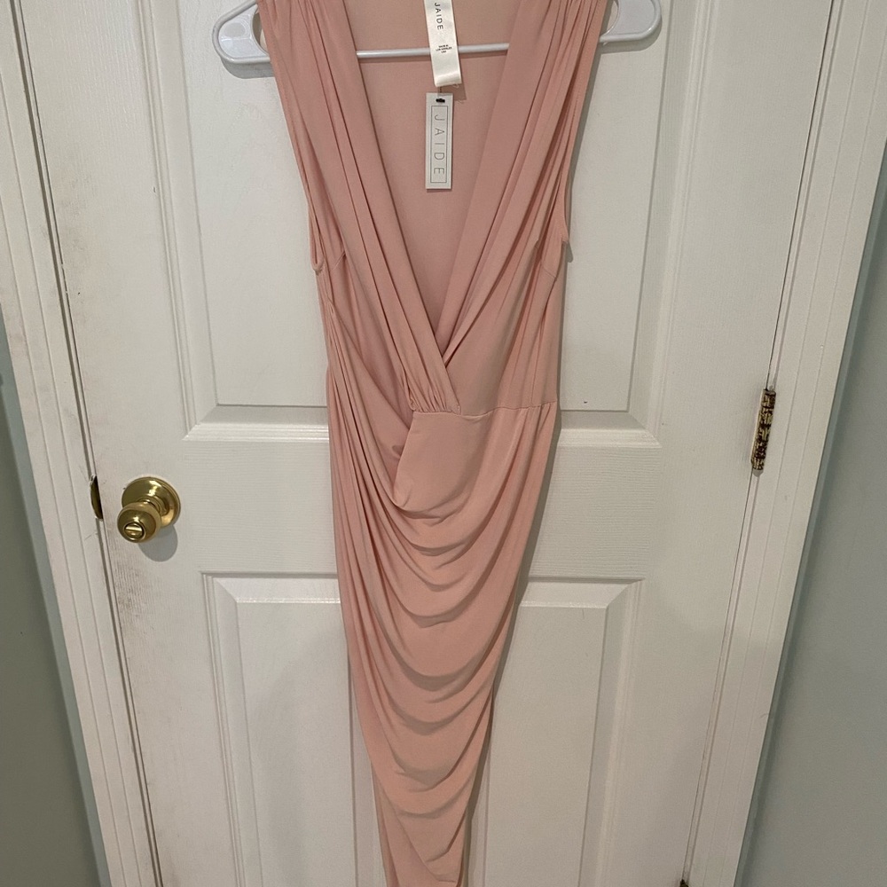Brand new pink dress.. snug fit with a slit on the right side and low cut.